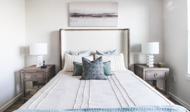 Studio, 1, 2 & 3 bedroom apartments Bed with pillows and nightstands