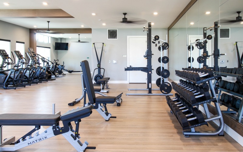 fitness room with weights and treadmills